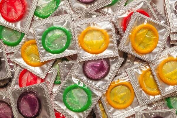 Colourful colllection of condoms in single packs -  birth control methods