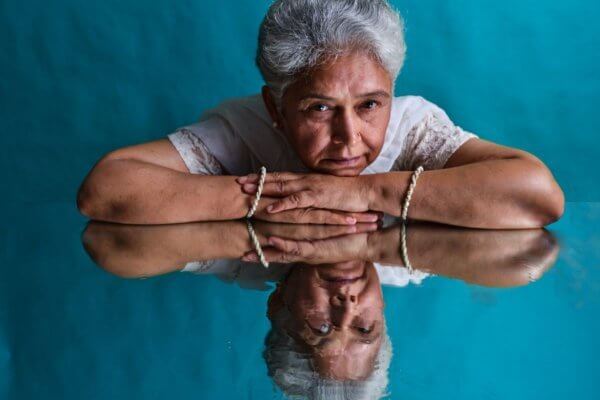 Dementia and Insight - senior black lady and reflection 