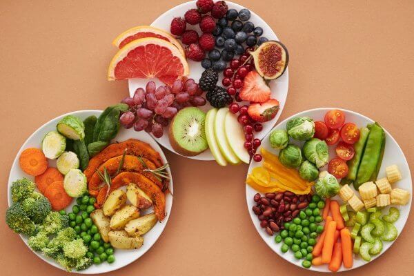 image shows 3 bowls of food - mixture of fibre containing fruits and vegetables - one of the causes of internal heat can be treated with diet