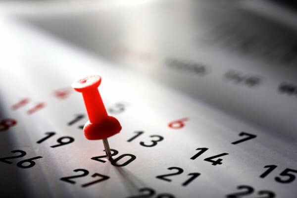 Calculating Ovulation Day with a Calendar - image of a calendar with a red pin on the 20th day