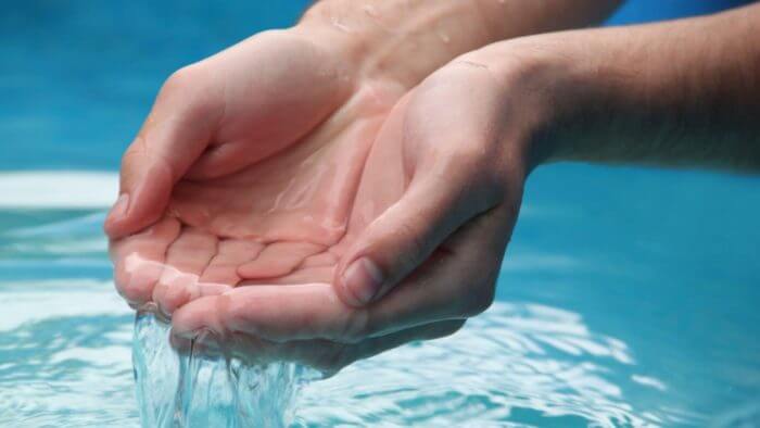 Cupped hands in clean water
