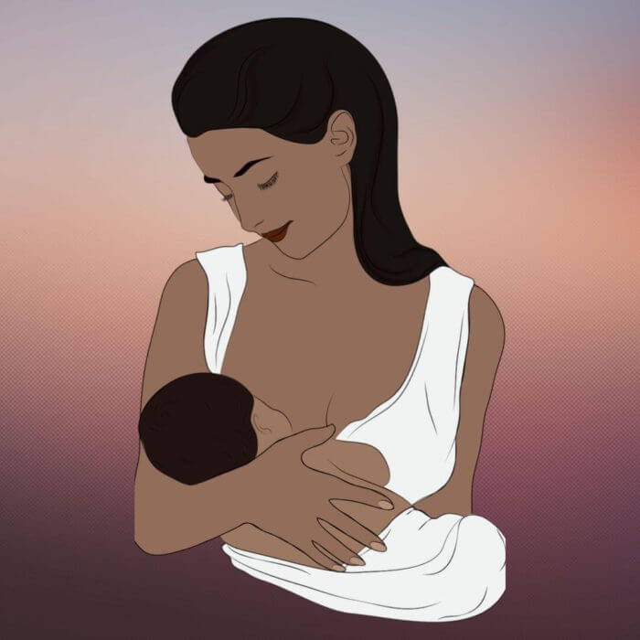Portarit of a mum looking tenderly down on her baby while breastfeeding