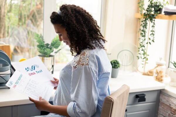 lady analyst holding some DNA test reports