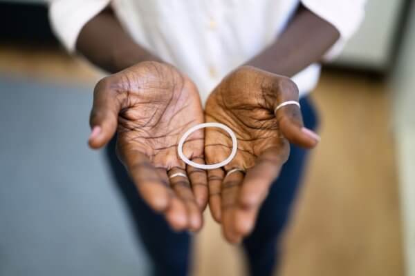 lady holding vaginal ring in her open palms